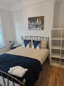 a bedroom with a bed with blue and white pillows at Marina Bed Liverpool City LFC in Liverpool