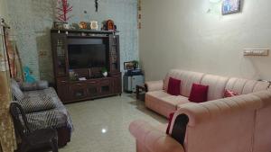 a living room with two couches and a television at Estateview Villa Homestay in Sakleshpur +17 photos