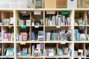 a book shelf filled with lots of books at Bunagaya in Ujimi