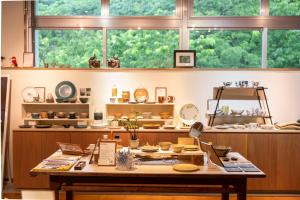 a room with a table and a large window at Bunagaya in Ujimi