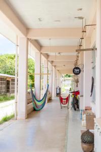 a porch with two hammocks hanging from the ceilings at Bunagaya in Ujimi