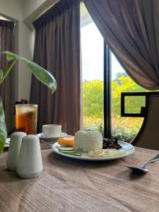a plate of food on a table with a window at Villa Verde Guest House in General Santos +5 photos