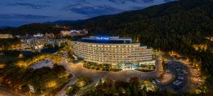 a hotel in a city at night with a parking lot at The K Hotel Gyeongju in Gyeongju