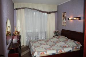 a bedroom with a bed and a window at LUX central apartment in Dnipro