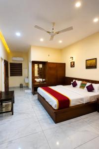 a bedroom with a large bed and a bathroom at Maple grove villa resort in Panamaram