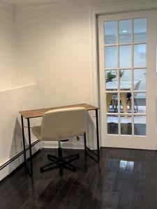 a table and a chair in a room with a window at Studio - NYC, Greenwich, Capitol, Parking in Port Chester