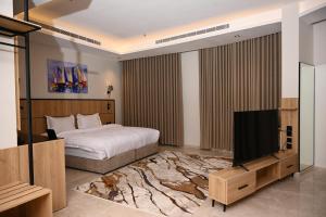 a bedroom with a bed and a flat screen tv at فندق أونارا ستاي in Medina +19 photos