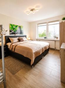 a bedroom with a large bed and a window at Ferienwohnanlage Majorcas in Dahme +128 photos