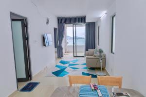 a living room with a view of the ocean at Napoleon Apartment Nha Trang - Gần Biển Hòn Chồng in Nha Trang
