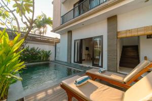 a swimming pool in the backyard of a house at Villa Raka by Manara in Legian