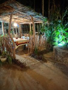a room with a table and chairs and plants at Evergreen Resort Ella in Ella