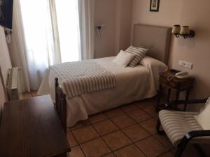 Postel nebo postele na pokoji v ubytování Hotel Patri