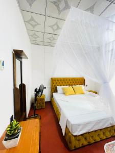 a bedroom with a bed with a net at Villa Dinusara in Weligama