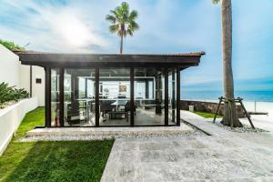 a glass house with a view of the ocean at ヴィラモンタン・淡路 in Akashi