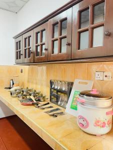 a kitchen counter with a stove with a pot on it at Villa Dinusara in Weligama