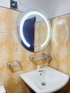 a bathroom with a sink and a mirror at Villa Dinusara in Weligama +24 photos