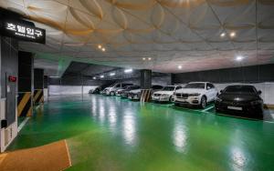 a parking garage with a bunch of cars parked in it at Hotel Midas in Daegu