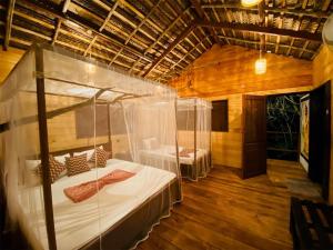 a bedroom with a canopy bed in a room at Tree House Cabana Sigiriya in Sigiriya