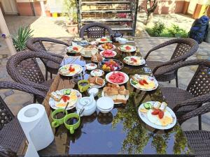 a wooden table with plates of food on it at SAMARKAND AMIRA in Samarkand