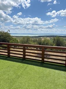 a wooden fence with a view of the countryside at Mona-Lak Balaton Panorama in Zánka