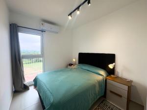 a bedroom with a bed and a large window at Departamento cerca a Asunción 412 in Luque +32 photos