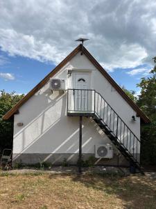 a building with a staircase on the side of it at Mona-Lak Balaton Panorama in Zánka +20 photos