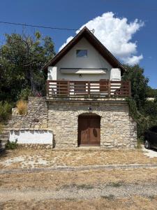 a house with a balcony on top of it at Mona-Lak Balaton Panorama in Zánka