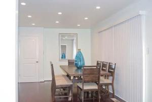 a dining room with a table with chairs and a vase on it at Silicon Valley Stays Casa Uno in Mountain View