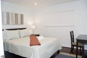 a bedroom with a bed with a table and a window at Silicon Valley Stays Casa Uno in Mountain View +52 photos