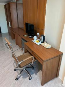 a desk with a chair and a computer on it at Utc Damhil By Prasanthi in Telaga