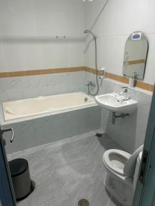 a bathroom with a sink and a toilet and a bath tub at Utc Damhil By Prasanthi in Telaga +13 photos