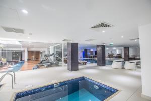 a hotel lobby with a swimming pool and a gym at Anmaria Beach Hotel & Spa in Ayia Napa
