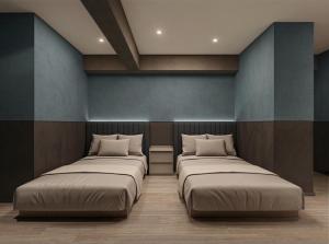 two beds in a room with blue walls at KABIN Shiro - Regale Collection in Osaka