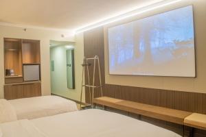 a hospital room with two beds and a projection screen at EGI Cebu Resort and Hotel in Maribago