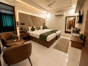 a hotel room with a bed and a chair at Hotel Dev Vilas 600 Metres from Taj Mahal in Agra