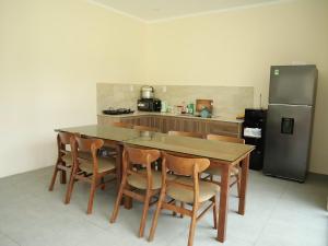 a kitchen with a table and chairs and a refrigerator at 86 Villa in Mui Ne