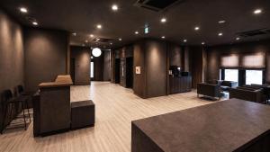 an office with a lobby with a bar and chairs at KABIN Shiro - Regale Collection in Osaka