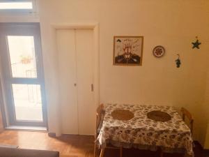 a room with a table and a window and a door at Lungomare Crotone in Crotone