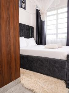 a bedroom with two beds and a window at Calvin's corner in Kisumu