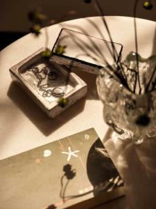 a table with a vase and a card on it at is.land Villa in Sanya +38 photos