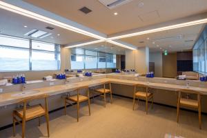 a large bathroom with a row of sinks and mirrors at REX HOTEL Beppu in Beppu +53 photos
