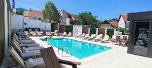 a swimming pool with chaise lounge chairs and a swimming pool at Sky Panorama in Soko Banja