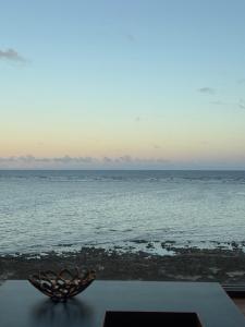 a bowl sitting on a table next to the ocean at HERO VILLA ocean suite in Ishigaki Island