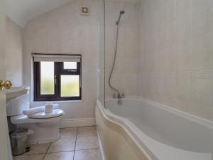 a bathroom with a tub and a toilet and a sink at 4 Green Farm Cottage in Chester +33 photos