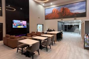 a restaurant with tables and chairs and a large screen at Quality Inn Casa Grande I-10 in Casa Grande