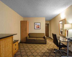 a living room with a couch and a desk at Comfort Inn Regina East in Regina
