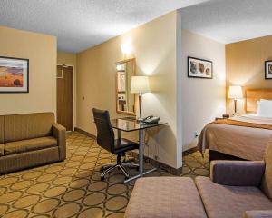 a hotel room with a bed and a desk at Comfort Inn Regina East in Regina