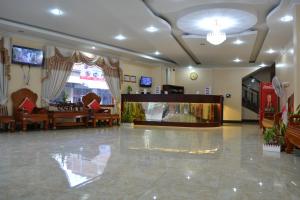 a lobby with a waiting room with a large screen at Capital Battambang Hotel in Battambang