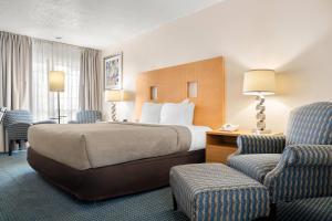 a hotel room with a bed and a chair at Quality Inn Rock Springs - Green River in Rock Springs +24 photos