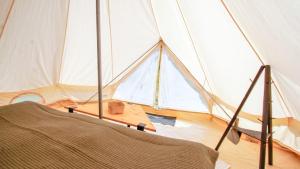 a large tent with a bed in a room at Venejoen Piilo - Sammal in Joensuu